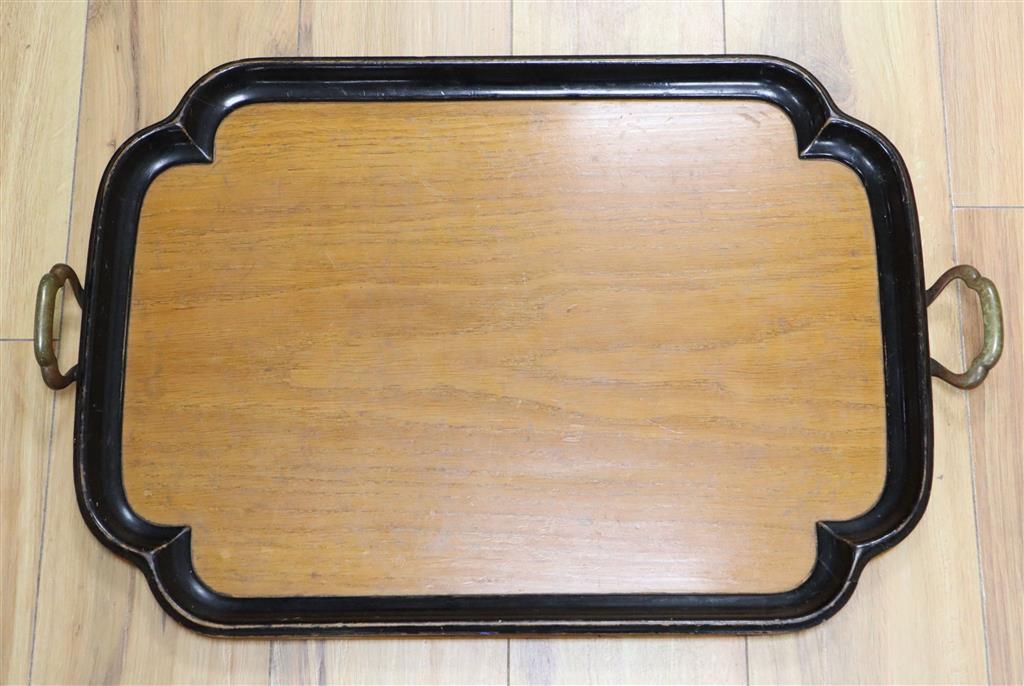 An Edwardian walnut and ebonised framed two handled tea tray, width 65cm